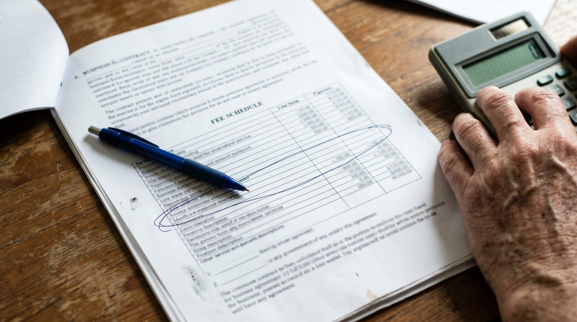 A contract page showing a fee schedule with one row circled in pen